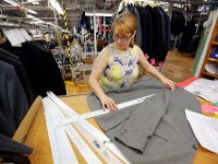 Carmen Martins measures custom suit jackets, at the Joseph Abboud manufacturing plant in New Bedford, MA.   [ PETER PEREIRA/THE STANDARD-TIMES/SCMG ]